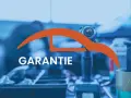 Werkstatt-Szene mit Werkzeug und dem Wort "GARANTIE". Informiert über die Dauer der Garantie auf Reparaturen und Ersatzteile für Autos.
