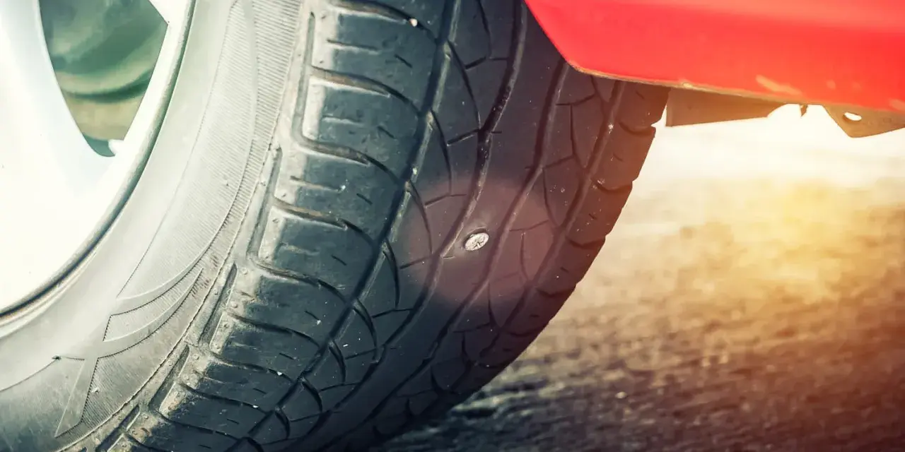 Ein Nagel steckt in einem Autoreifen, aber keine Sorge, reifen flicken erlaubt!