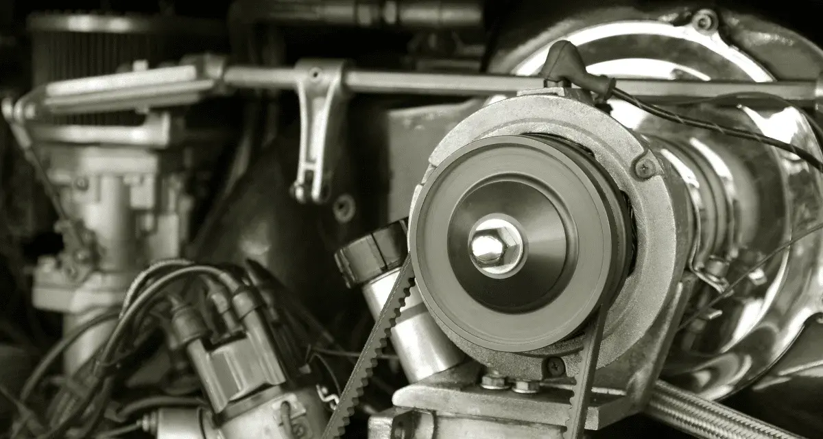 Nahaufnahme eines Motors, bei dem der Keilriemen gerissen ist. Man sieht die Riemenscheibe und Teile des Motors.