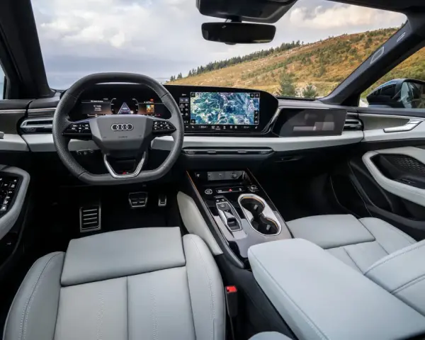 Moderner audi a6 innenraum mit großem Infotainment-Display und digitalen Instrumenten, bereit für die Fahrt durch malerische Landschaften.