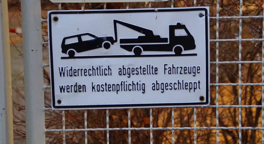 Schild: Widerrechtlich abgestellte Fahrzeuge werden kostenpflichtig abgeschleppt. Was tun, wenn das Auto abgeschleppt wurde?