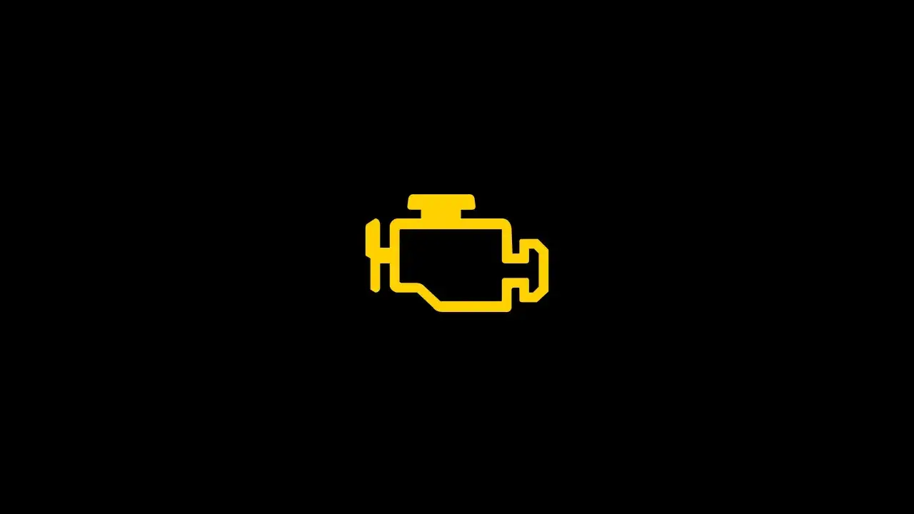 Gelbe Motorleuchte leuchtet auf schwarzem Hintergrund. Ein Warnsignal, das auf ein Problem mit dem Motor hinweist.